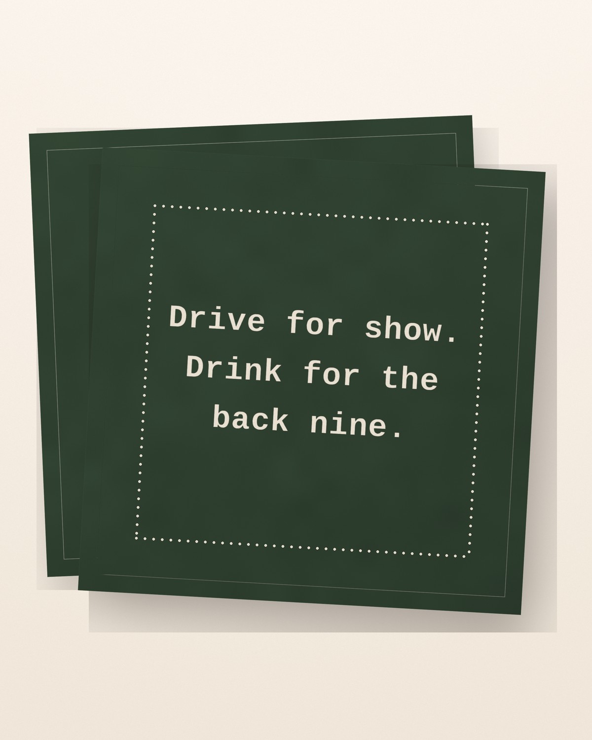 A forest-green Five Star cotton cocktail napkin printed with ‘Drive for show. Drink for the back nine.’